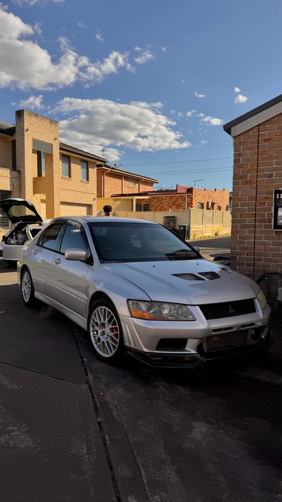 Silver Mitsubishi Lancer Evolution on a driveway during a mobile detail