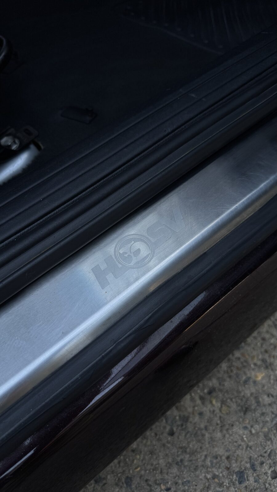 Clean HSV door sill plate beside glossy plum paint