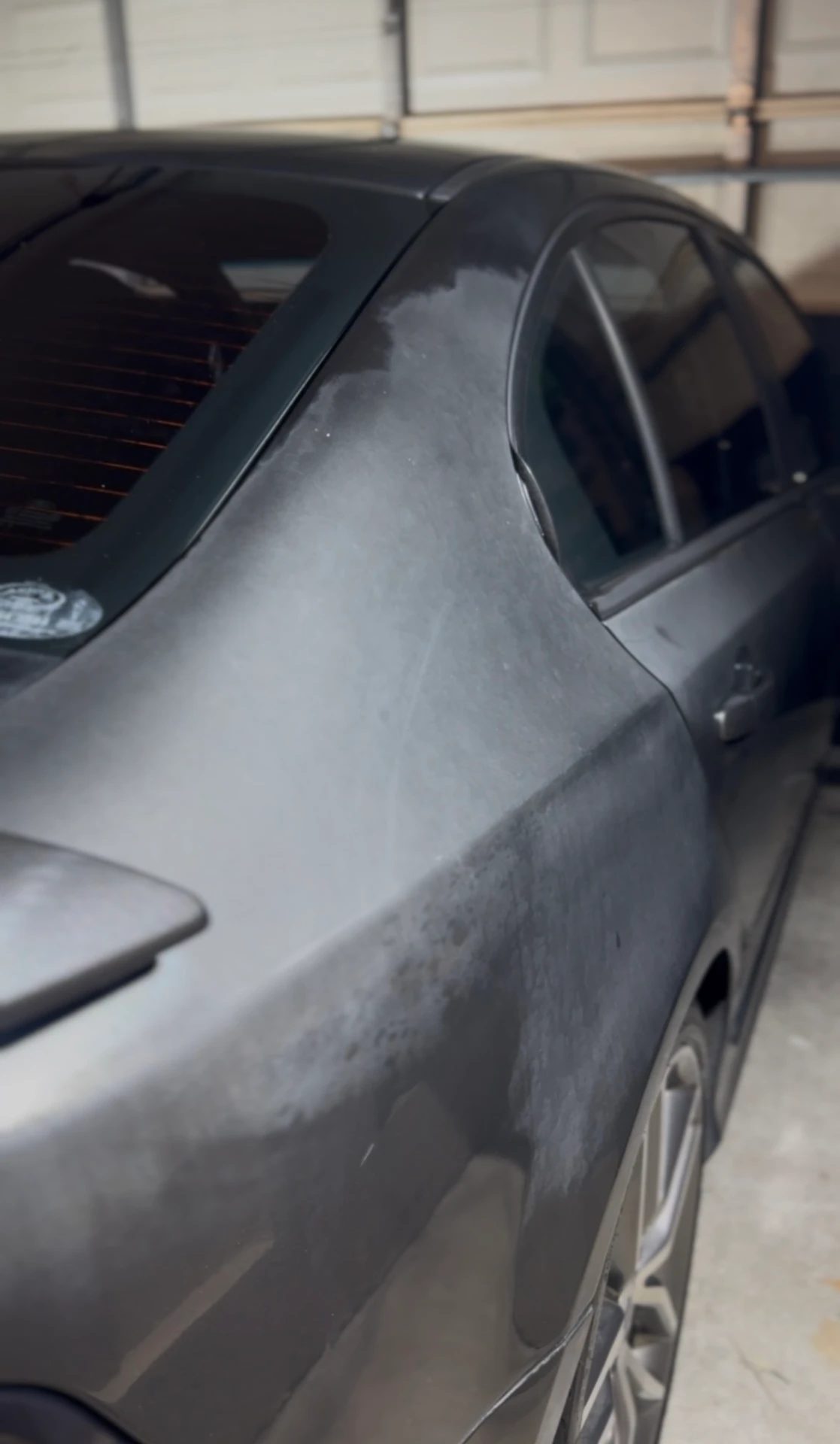 Grey Ford Falcon rear quarter panel with chalky, oxidised and blotchy paint